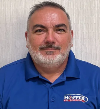 Man with short gray hair wearing HOFFER Pest Solutions shirt.